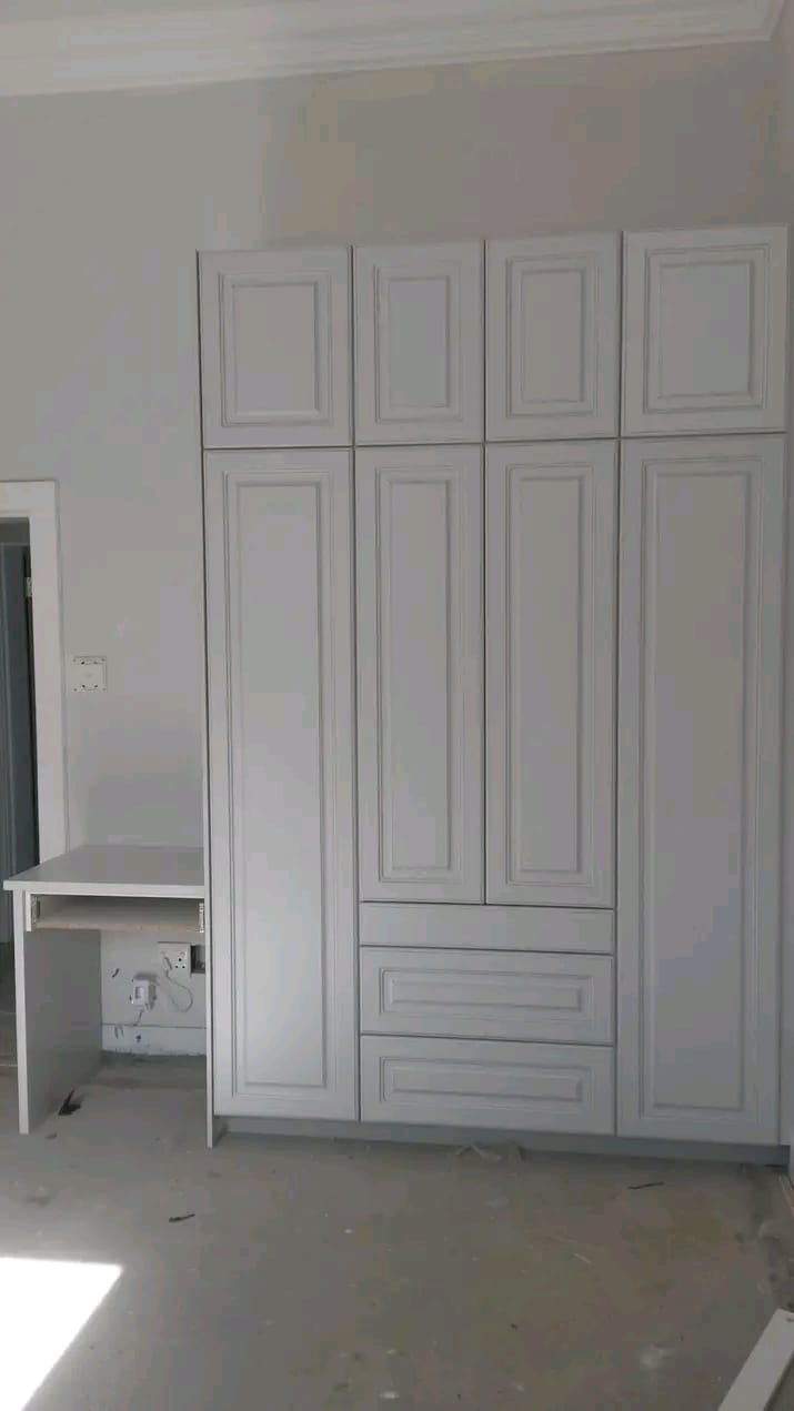Floor-to-ceiling built-in wardrobe with desk