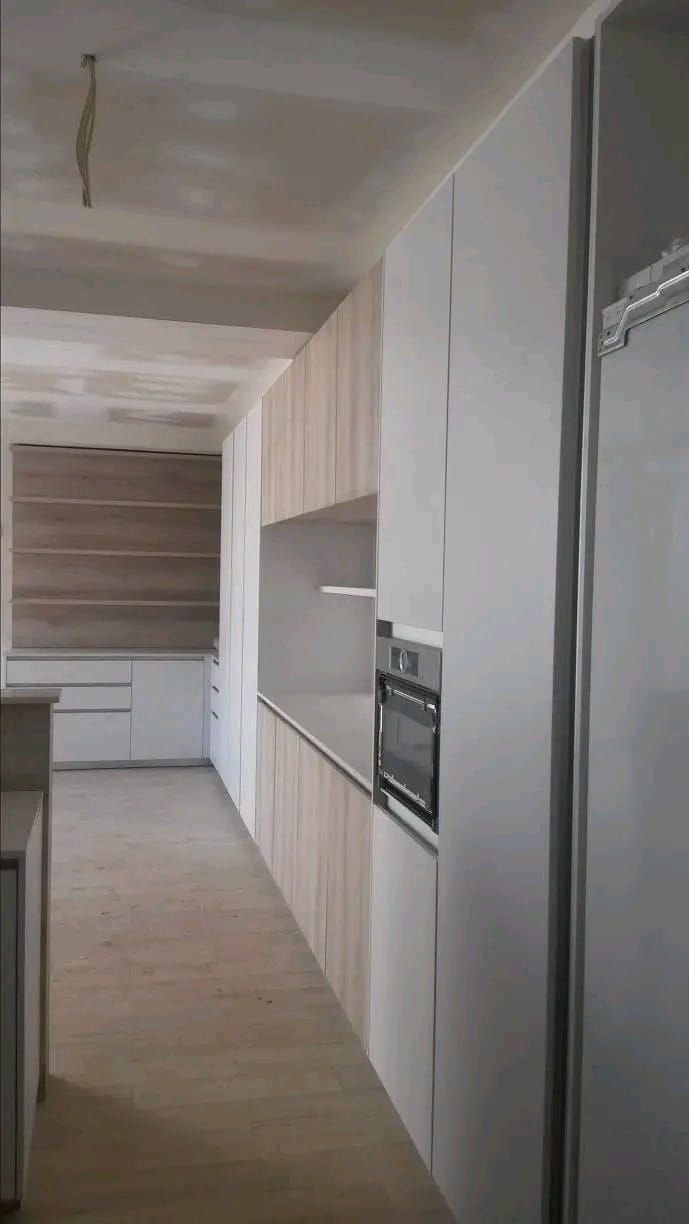 Light timber galley kitchen with built-in oven